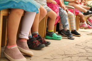 children's legs in seated line
