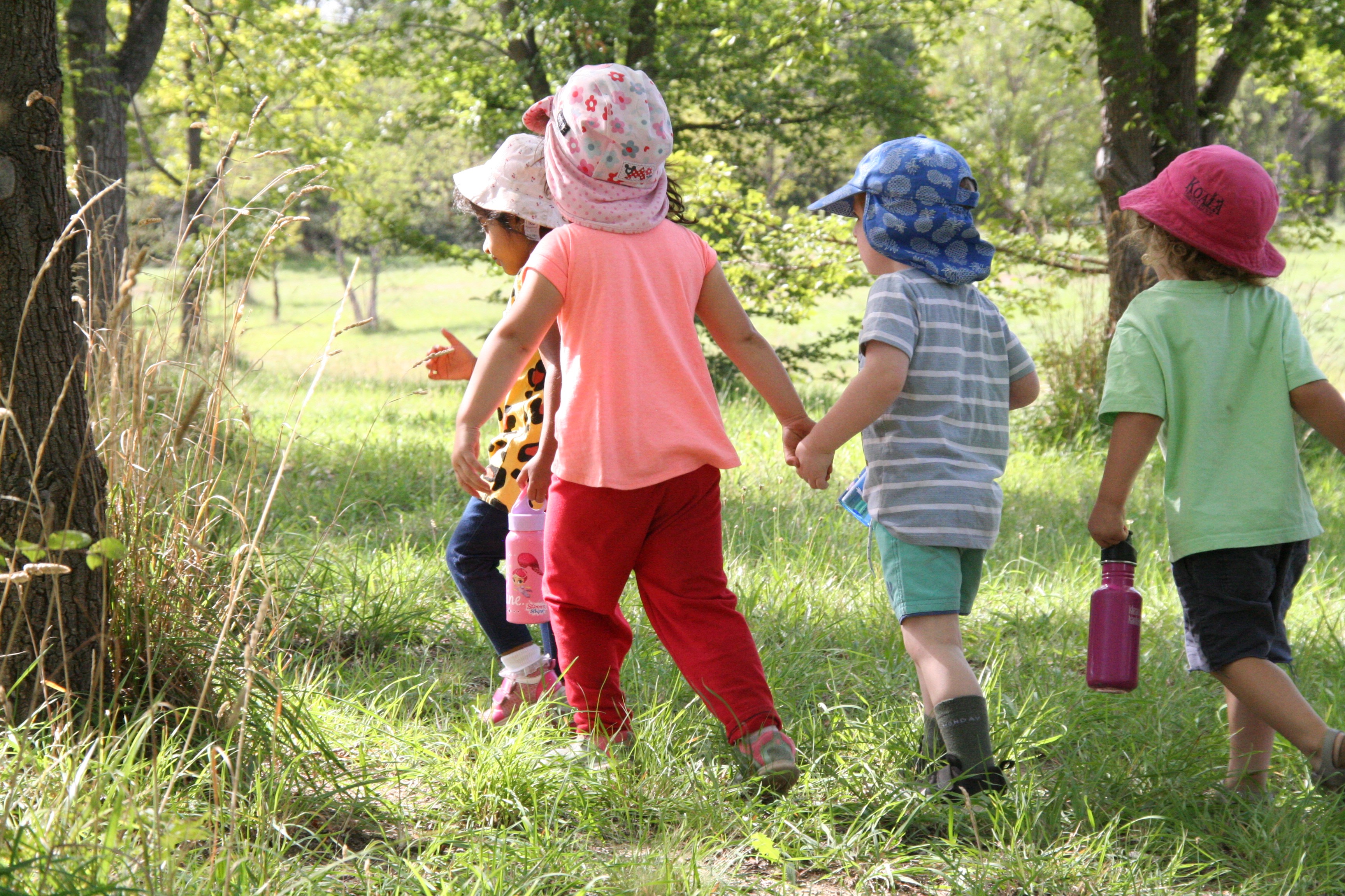 Children holding hands outdoors
